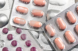 Colorful pink of tablets and capsules pill in blister packaging arranged. Pharmaceutical industry concept. Pharmacy drugstore.