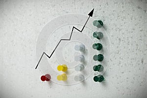 Colorful pins on polystyrene business growth chart.