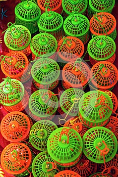 Colorful Plastic Bird Cages in Repetitive Pattern Display