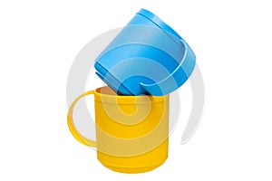 Colorful plastic blue and yellow cups on a isolated white backg