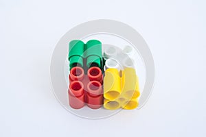Colorful plastic bricks and details of toys on a white background. Top view