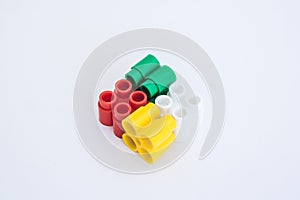 Colorful plastic bricks and details of toys on a white background. Top view