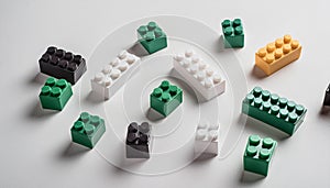 Colorful plastic building blocks scattered on a white background