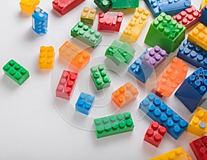 Colorful plastic building blocks scattered on a white background