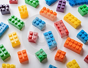 Colorful plastic building blocks scattered on a white background