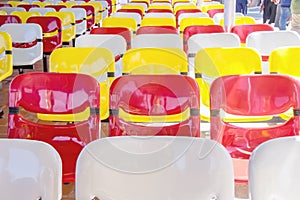 Colorful plastic chairs row red yellow and white nobody on background