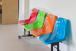 colorful plastic chairs in row for waiting room in hospital