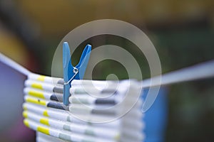 colorful plastic clothespin holding the washer on a string stretched in the garden