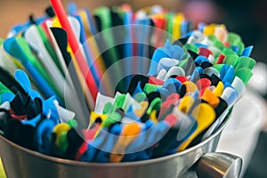 Colorful plastic drinking straws in aluminium bowl