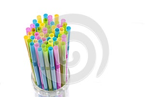 Colorful plastic drinking straws in the glass.