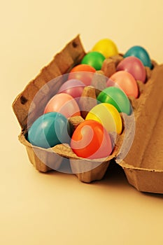 Colorful plastic Easter eggs in an egg carton