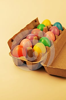 Colorful plastic Easter eggs in an egg carton