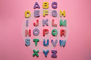 Colorful plastic englisch alphabet letters on pink background photo