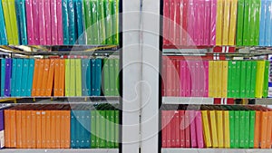colorful plastic folders neatly arranged on the office shelf