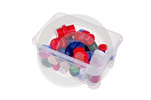 Colorful plastic lids in a box isolated on white background, with clipping path