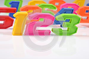 Colorful plastic numbers 123 on white