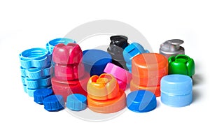 Colorful plastic plugs for recycling on white background
