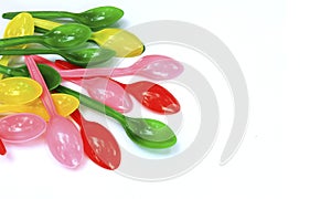 Colorful plastic spoon on a white background