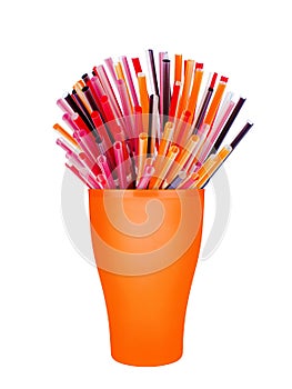 Colorful plastic straws in cup white background isolated close up, disposable drinking pipes in glass, tubes for beverage cocktail