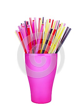 Colorful plastic straws in cup white background isolated close up, disposable drinking pipes in glass, tubes for beverage cocktail