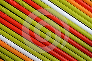 Colorful plastic straws on a dark background