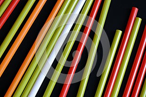 Colorful plastic straws on a dark background