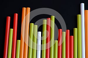 Colorful plastic straws on a dark background