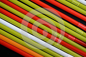 Colorful plastic straws on a dark background