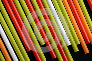 Colorful plastic straws on a dark background