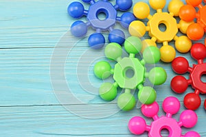 colorful plastic toys on blue wooden background. Top view. Toys in the table