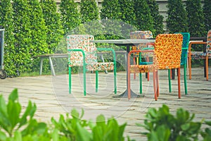 Colorful plastic weaving rattan chair standing on concrete floor.