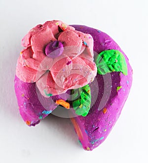 Colorful Plasticine or Clay cake with red rose