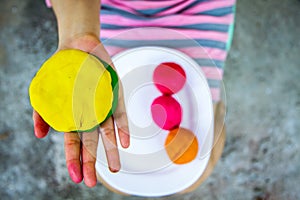 Colorful play dough on hand