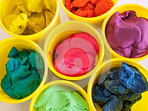 Colorful play dough in yellow can