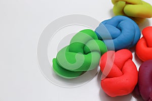 Colorful playdough close up image on white background.