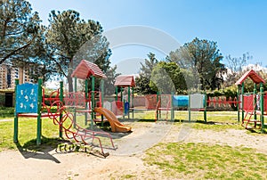 Colorful playground for kids inside a urban public park, Italy