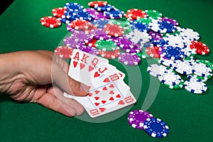 Colorful poker chips and royal flush