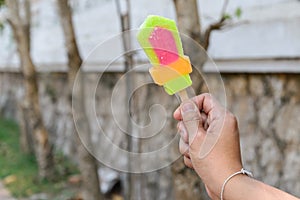 Colorful popsicle in hand