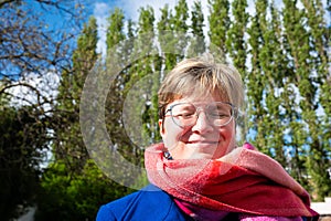 Colorful portrait of a 38 yo white woman outdoors, eyes closed, Brussels, Belgium