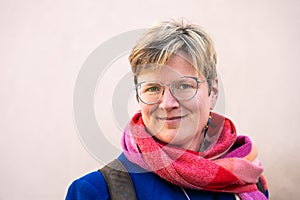 Colorful portrait of a 38 yo white woman with a salmon background, Brussels, Belgium