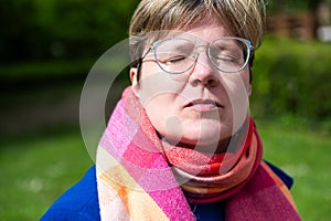 Colorful portrait of a 38 yo white woman with short hair, eyes closed, Brussels, Belgium