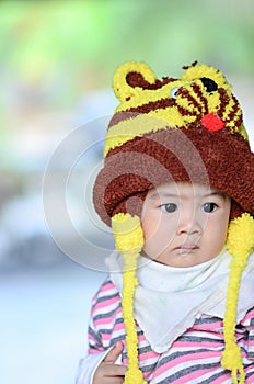 colorful portrait of cute baby boy dressed in lion custume,looking for something on blurry background. photo