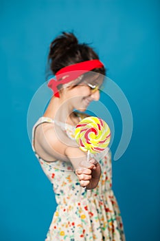 Colorful portrait young funny fashion girl posing on blue