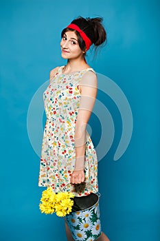 Colorful portrait of young funny girl posing on blue wall