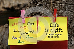 Colorful positive word concept written on yellow memo notepaper with inspirational quote - Life is a gift. A chance to grow better