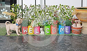 Colorful pots and painting welcome word - garden decoration