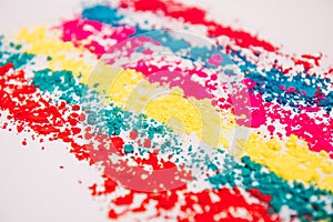Colorful powder rows on white background. Colorful dust. Paint Holi, close up. Abstract multicolor image