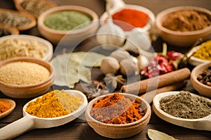 Colorful powder spices and herbs on the wooden table