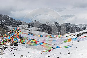 Colorful prayer flags on snow mountain