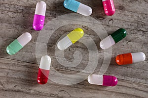 Colorful prescription pill capsules - medication on table